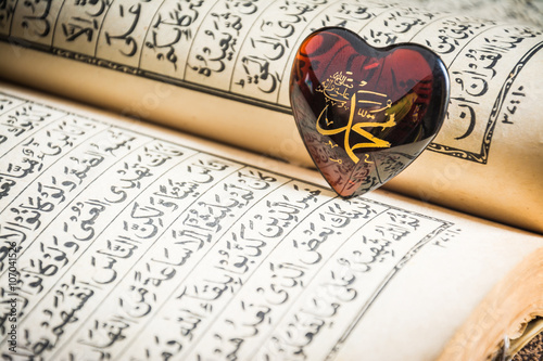 Muhammad prophet of Islam written on glass heart with Quran