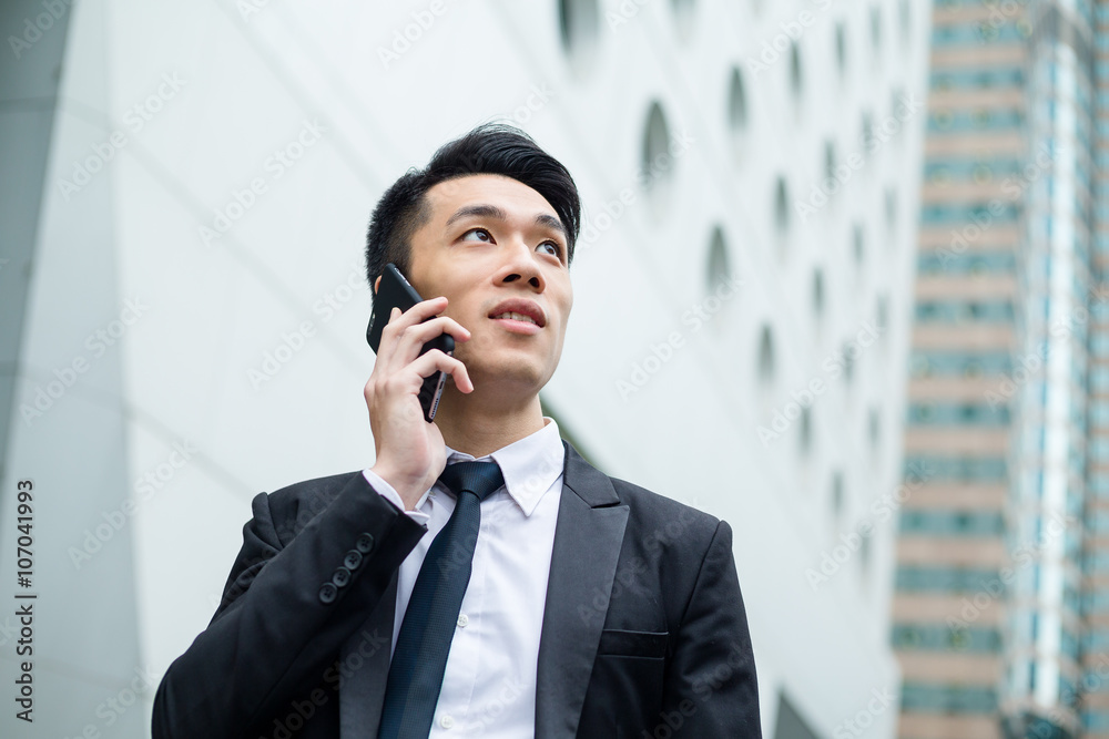 Businessman talk to cellphone at Hong Kong Businessman talk to cellphone at Hong Kong
