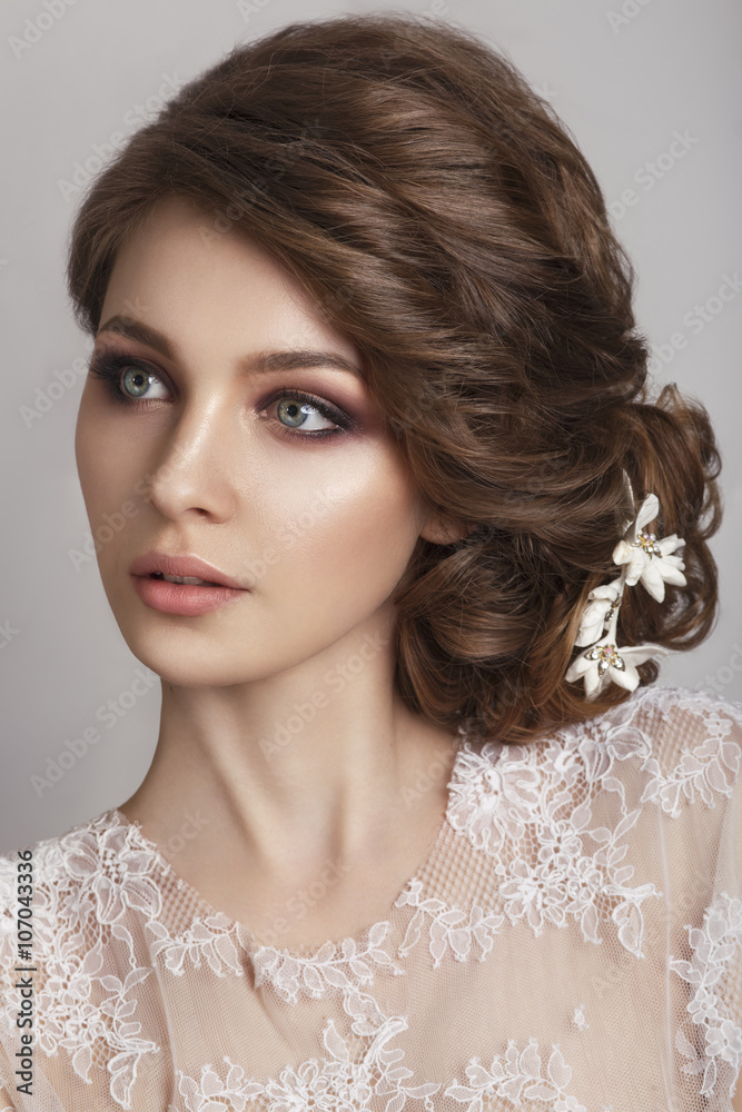 Beautiful bride with fashion wedding hairstyle - on white background.Closeup portrait of young gorgeous bride. Wedding. Studio shot. Beautiful bride portrait