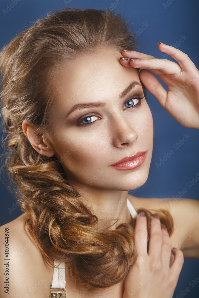 Fototapeta premium Beautiful bride with fashion wedding hairstyle - on blue background.Closeup portrait of young gorgeous bride. Wedding. Studio shot.Beautiful bride portrait 