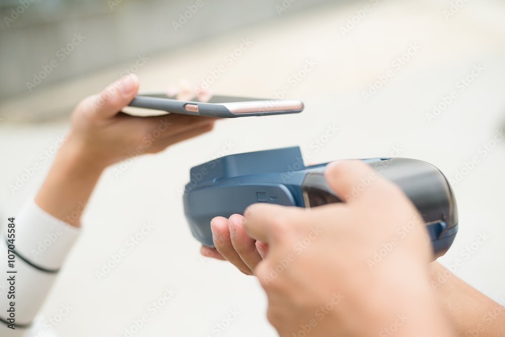 Fototapeta premium Customer pay on the bill with mobile phone