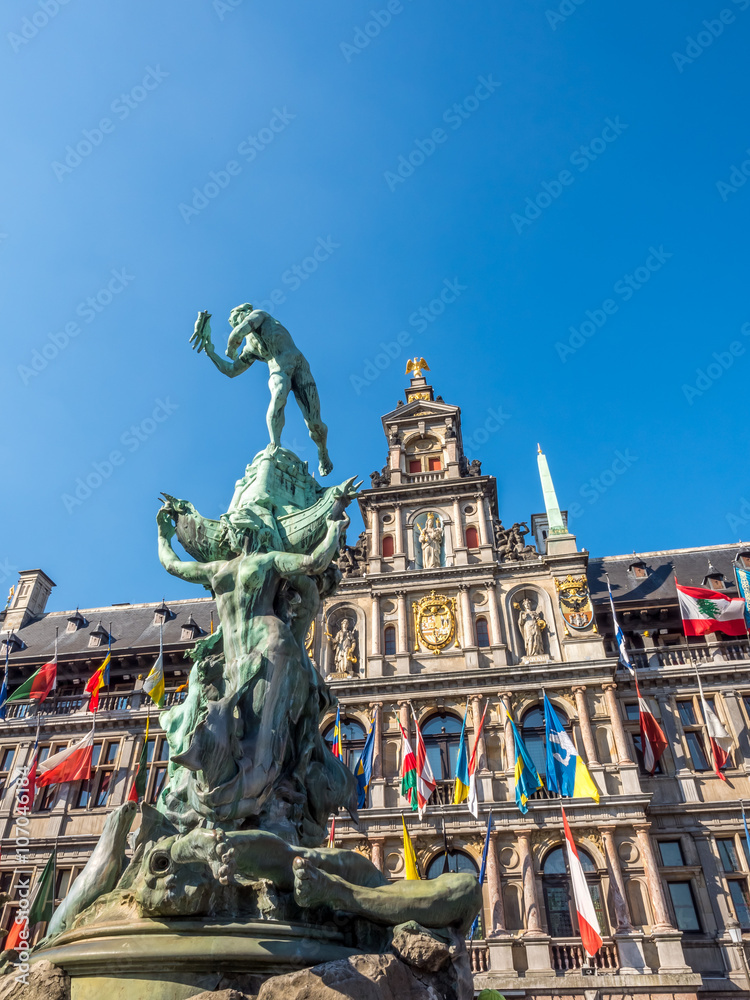 City Hall and Brabo fountain on the Great Market Square of Antwerp, Belgium, under clear blue sky in sunny weather day