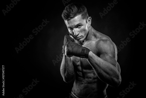 Portrait of attractive kickboxer in the dark