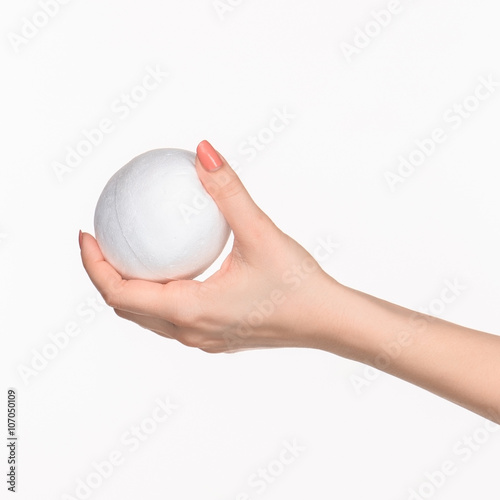The female hand holding white blank styrofoam oval 
