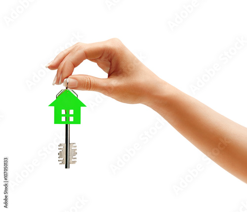 Woman's hand holding key to the apartment isolated on white background