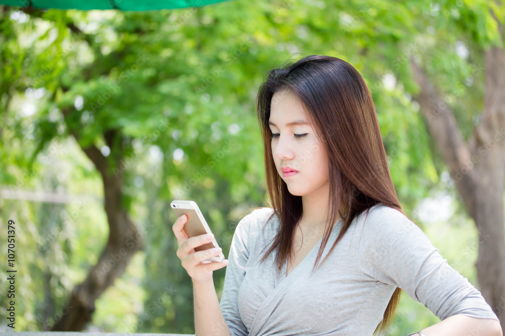 Portrait of thai adult beautiful girl using her smart phone. Portrait of thai adult beautiful girl using her smart phone.