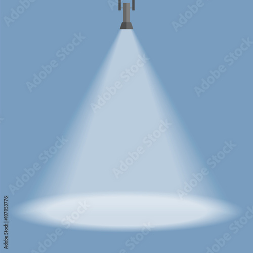 Spotlight shines down isolated on blue background.