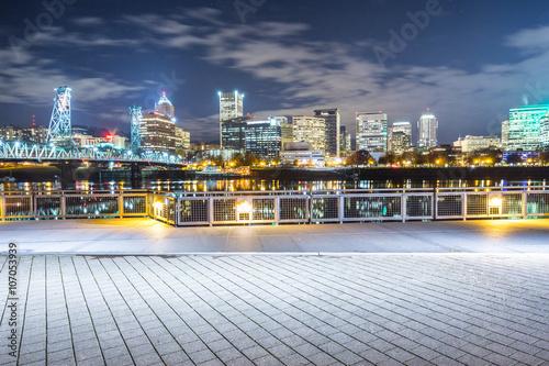 empty brick floor with cityscape and skyline of portland at nigh