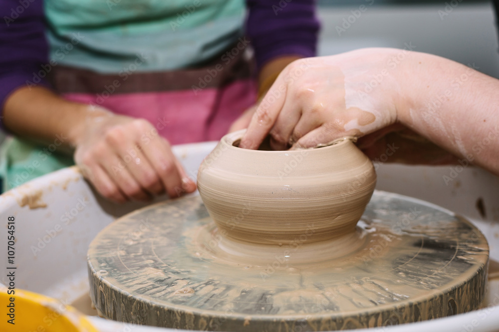 pottery. the teacher teaches the student work on the potter's wheel. pottery. the teacher teaches the student work on the potter's wheel.