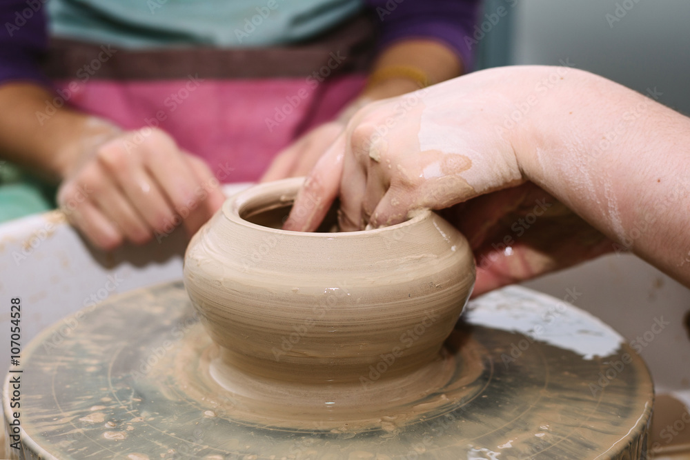 pottery. the teacher teaches the student work on the potter's wheel. pottery. the teacher teaches the student work on the potter's wheel.