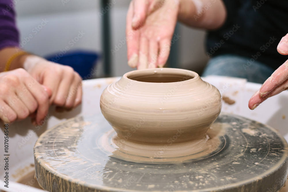 pottery. the teacher teaches the student work on the potter's wheel. pottery. the teacher teaches the student work on the potter's wheel.