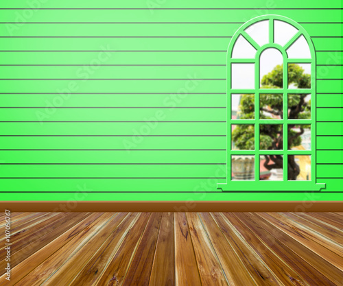 Empty room with wood floors and windows.
