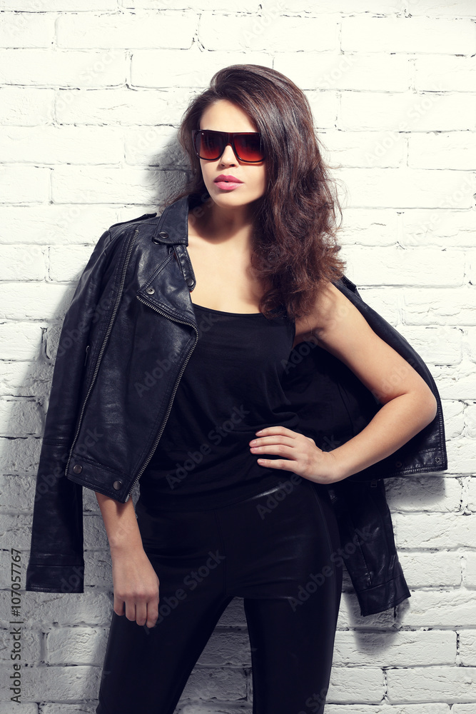 fashion model in sunglasses, black leather jacket, leather pants fashion model in sunglasses, black leather jacket, leather pants