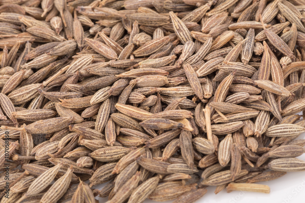 Seeds of caraway on white background