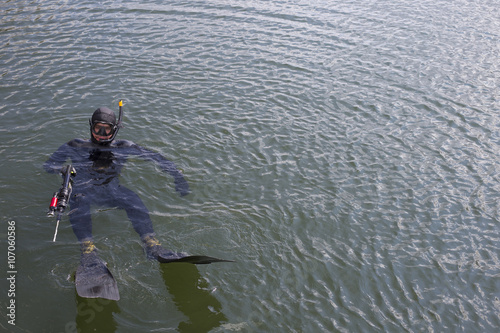 Underwater hunter dives into the sea.