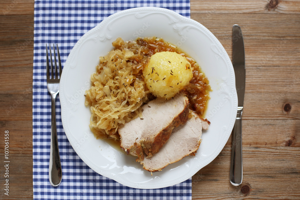 German roast pork with raspeball and sauerkraut 