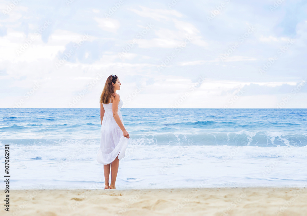 Beautiful woman in a white dress on the beach Beautiful woman in a white dress on the beach