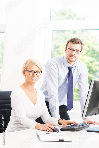 Office workers in formalwear working using computers