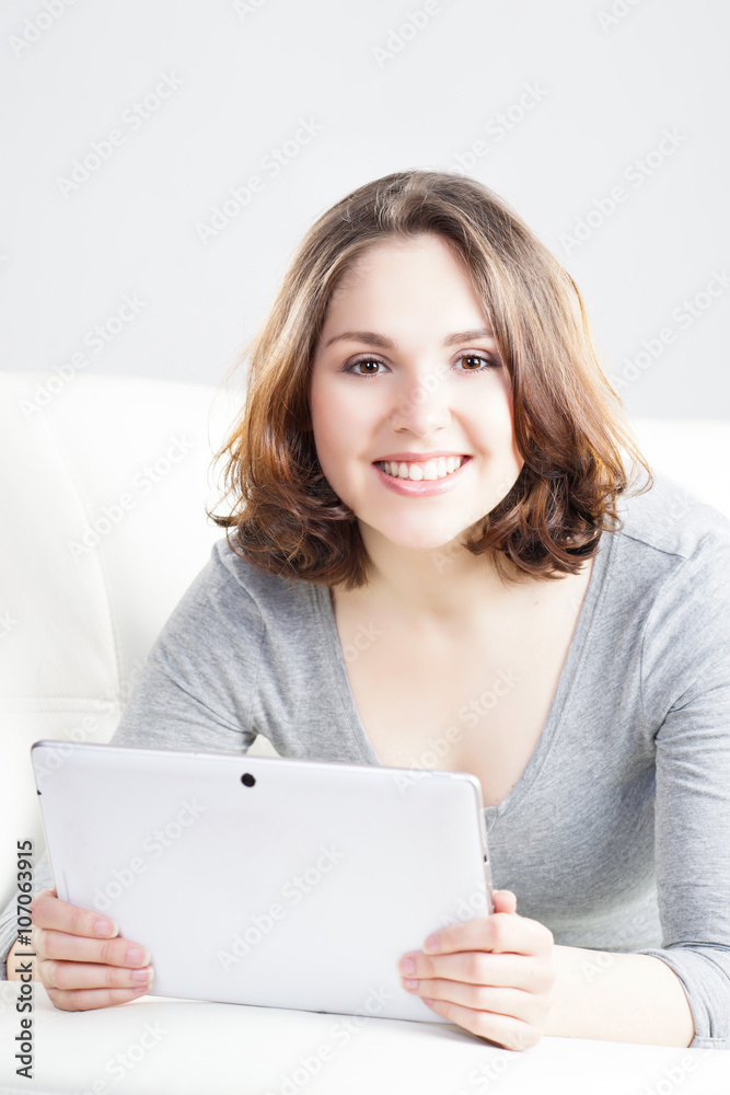 Attractive and young woman with a tablet computer at home Attractive and young woman with a tablet computer at home