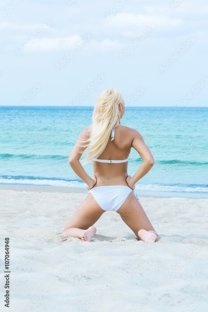 Young and fit girl in bikini on a summer beach