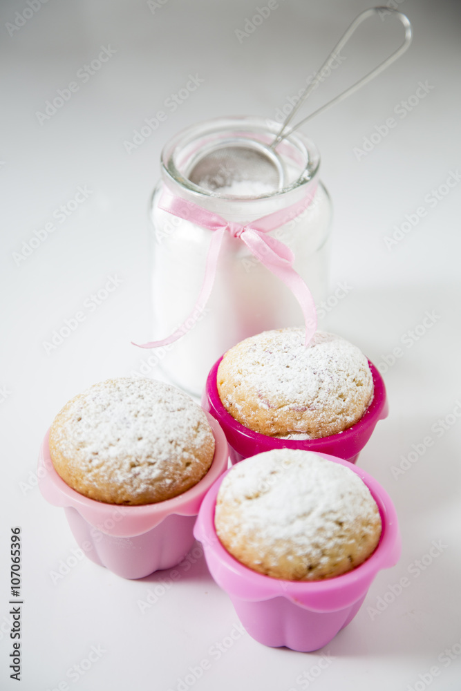 Freshly baked homemade muffins with powdered sugar Freshly baked homemade muffins with powdered sugar