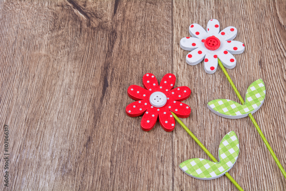 Creative handmade flowers on a wooden background Creative handmade flowers on a wooden background