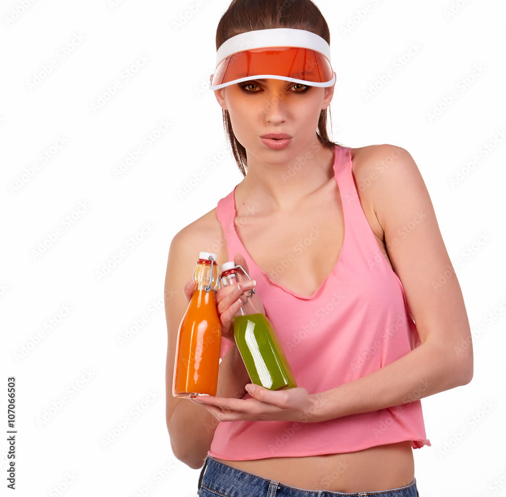 Smiling pretty young fitness woman in pink top holding juice Smiling pretty young fitness woman in pink top holding juice