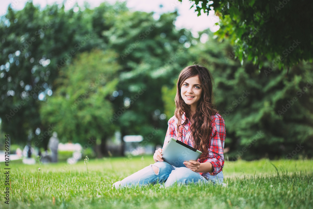 Woman with touchpad on outdoors.