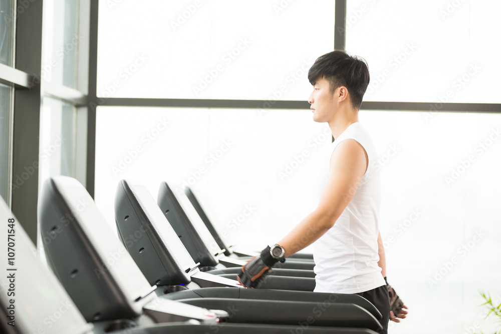 Fototapeta premium young handsome asian man works out in modern gym