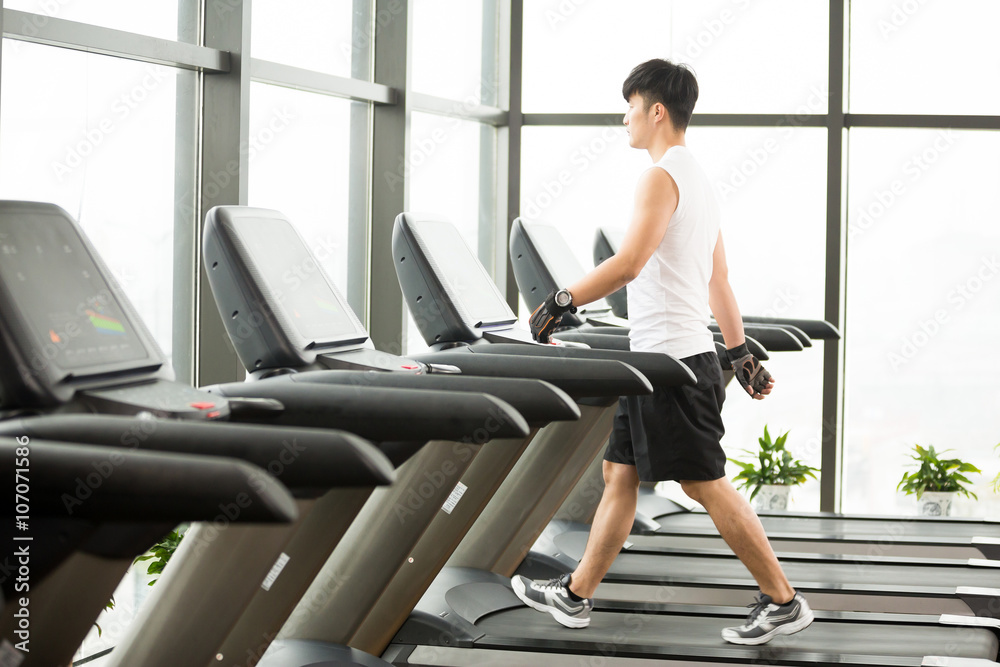 young handsome asian man works out in modern gym young handsome asian man works out in modern gym