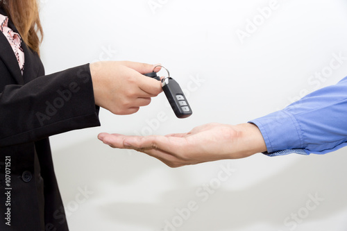 Business women giving a new key car to business man