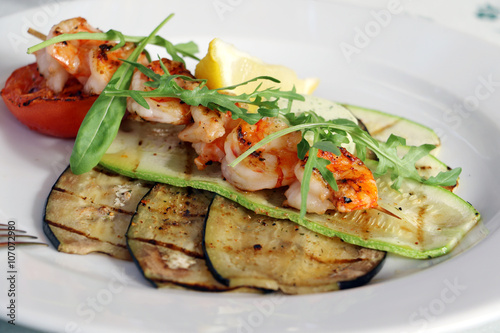 Shrimps on grilled vegetables.