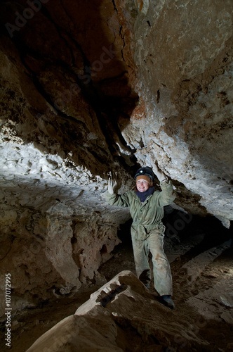  young female caver writing down cave photo