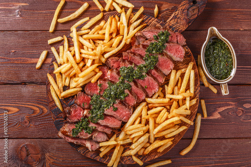 Beef barbecue ribeye steak with chimichurri sauce and french fri