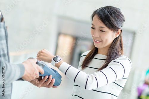 Woman pay by NFC on smartwatch