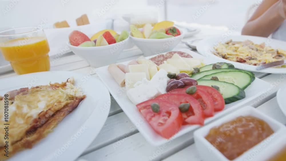 Breakfast table. Delicious breakfast served on table. Variety of food served on outdoor terrace. Breakfast table. Delicious breakfast served on table. Variety of food served on outdoor terrace.