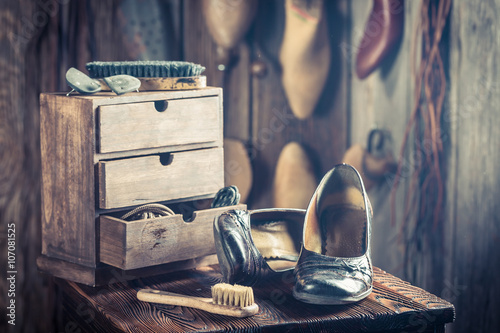 Old shoemaker workshop with tools, shoes and leather