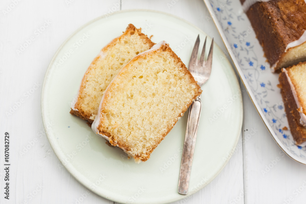 Lemon cake with icing decorated with lime slices Lemon cake with icing decorated with lime slices