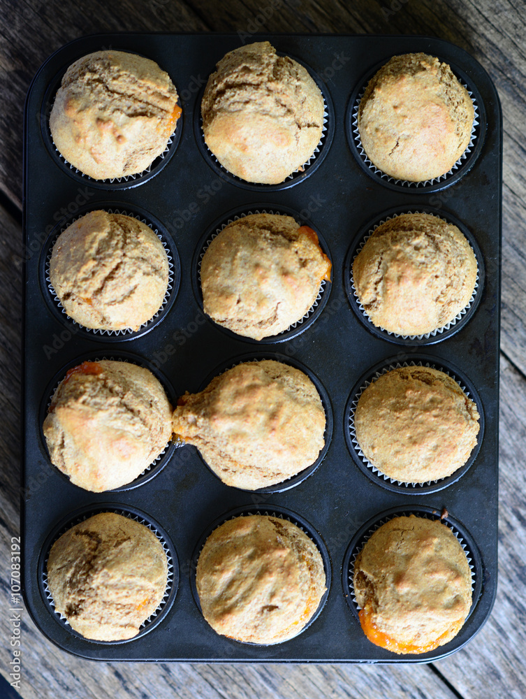 Healthy muffins with jam on wooden table Healthy muffins with jam on wooden table