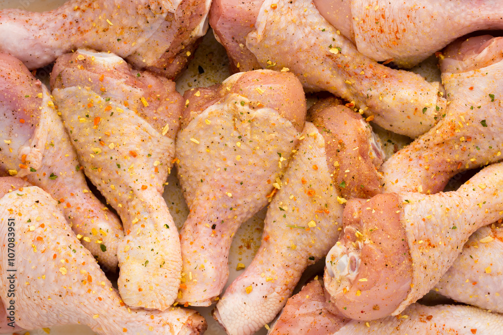 Fresh chicken leg, meat on plate.With spices. Fresh chicken leg, meat on plate.With spices.