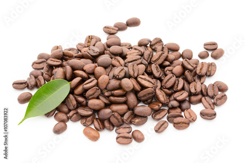 Coffee grains and leaves isolated on the white backgrounds.