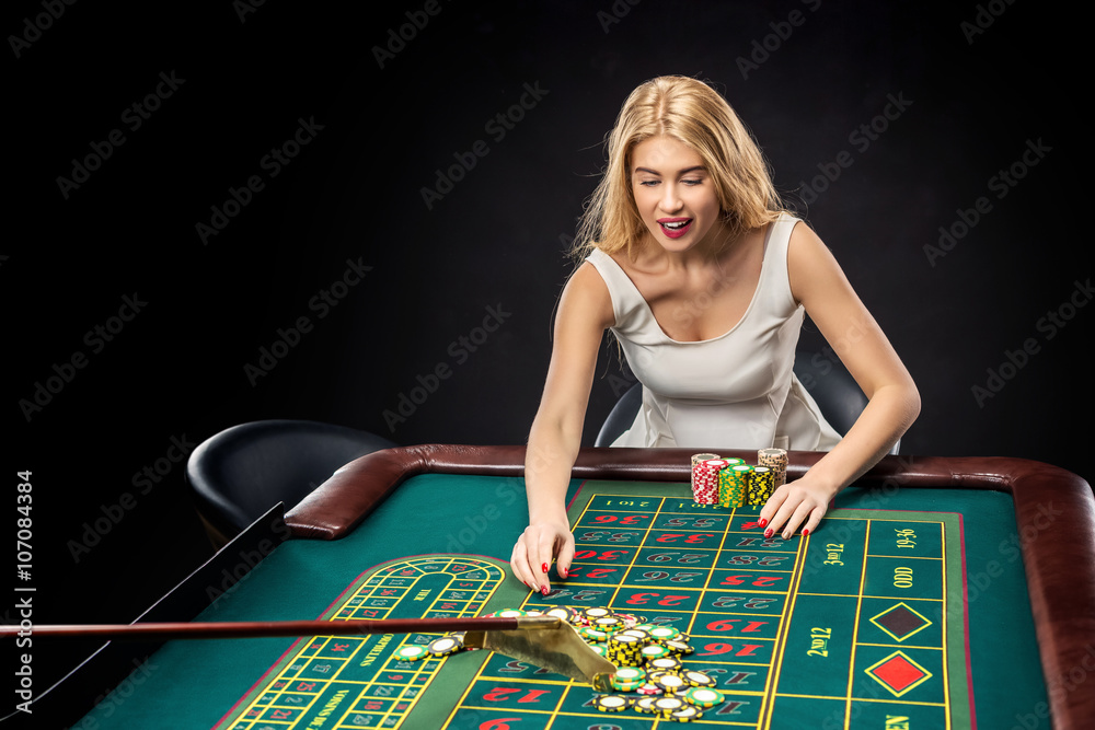 Young pretty women playing roulette wins at the casino Young pretty women playing roulette wins at the casino