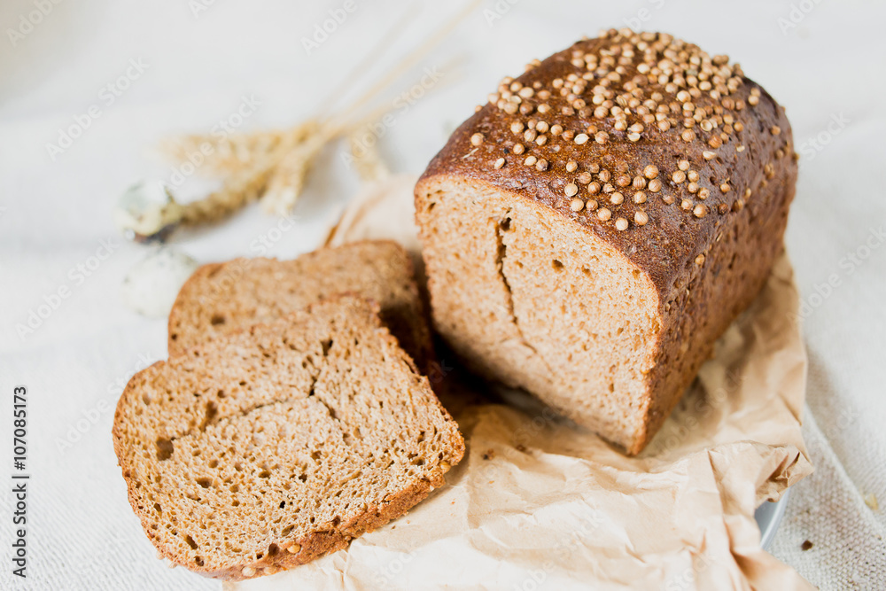 Black sliced bread with fresh coriander closeup Black sliced bread with fresh coriander closeup
