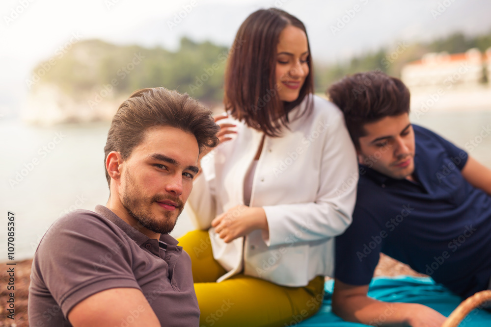 Obraz premium Three friends having fun at the beach, springtime