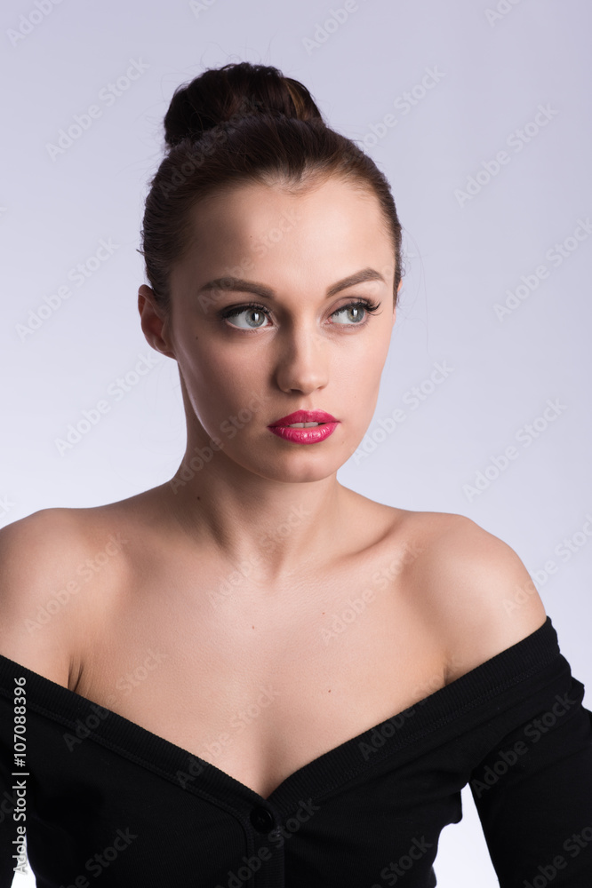 Vertical portrait of beautiful brunette in a black dress on a ne Vertical portrait of beautiful brunette in a black dress on a ne