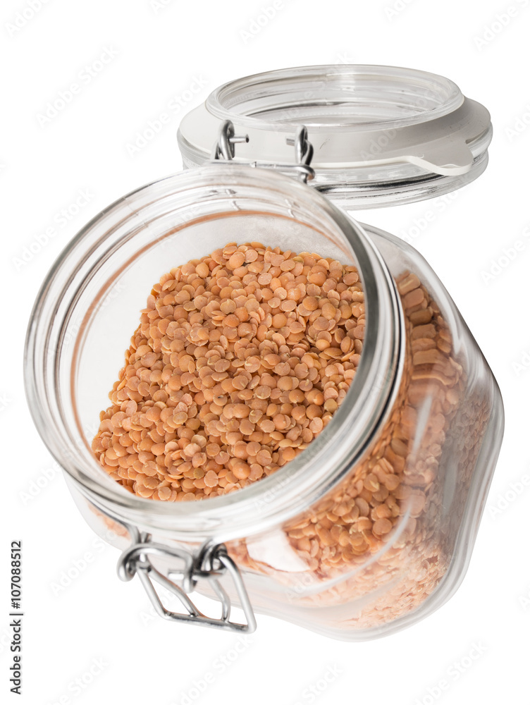 angled view of red lentils in a jar. angled view of red lentils in a jar.