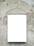 Close-up of one blank frame hanged by clothes hanger against grey weathered wall background