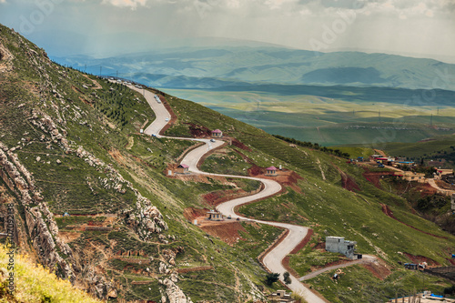Zigzag road leading to high mountain in Iraqi landscape photo