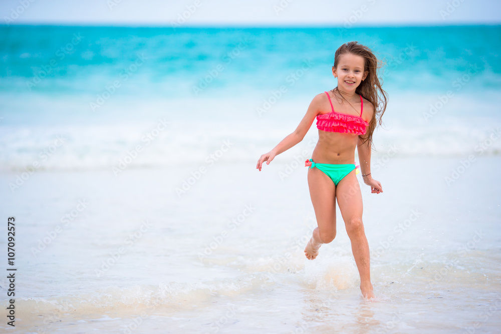 Adorable little girl at beach during summer vacation Adorable little girl at beach during summer vacation