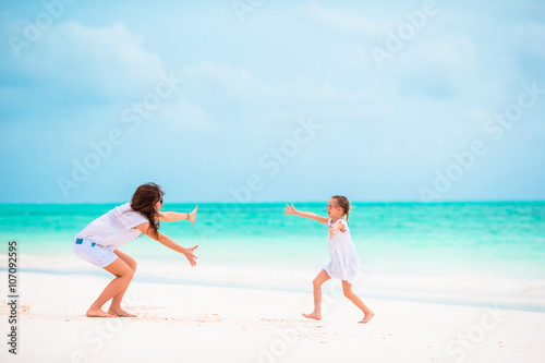 Happy family during summer vacation on white beach
